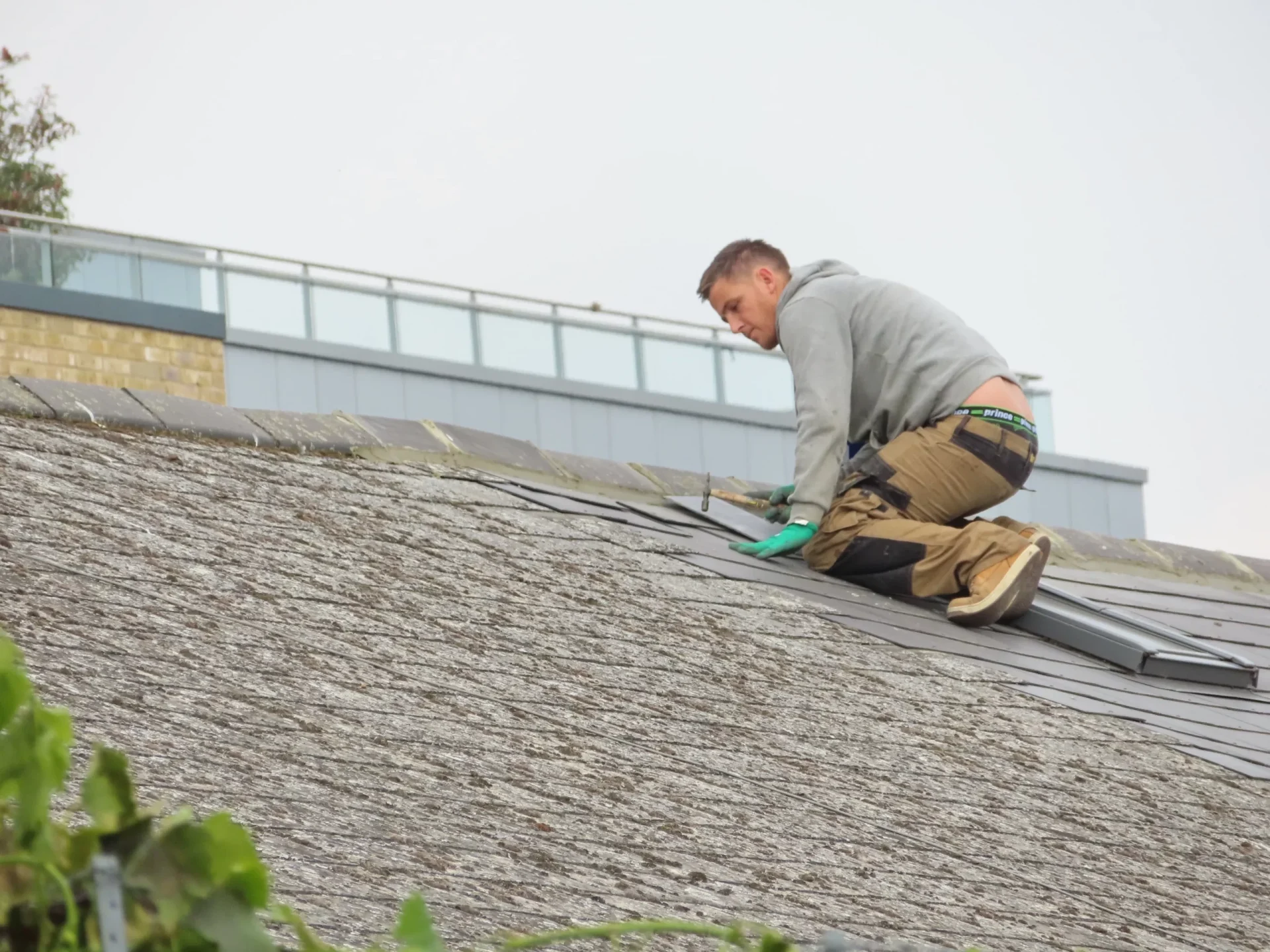 roof maintenance services in 2024 - man working on roof